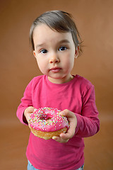 Image showing Little girl with  donut