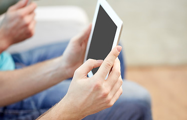 Image showing close up of male hands with tablet pc at home