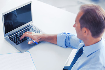 Image showing miling businessman working in office