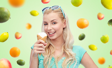 Image showing happy young woman in sunglasses eating ice cream