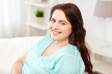 Image showing happy young plus size woman at home
