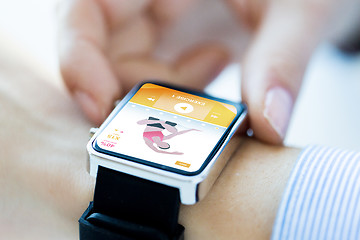 Image showing close up of hands setting sport app on smartwatch