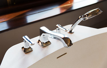 Image showing close up of bath tap and shower at bathroom