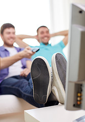 Image showing close up of happy male friends watching tv at home