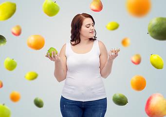 Image showing young plus size woman choosing apple or cookie