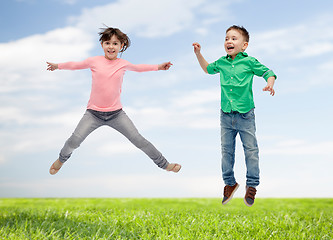 Image showing happy little girl jumping in air