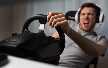 Image showing close up of man playing car racing video game