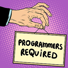 Image showing Hand holding a sign programmers required