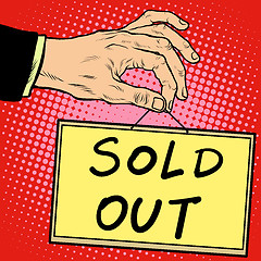 Image showing Hand holding a sign sold out