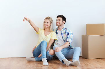 Image showing couple with boxes moving to new home and dreaming