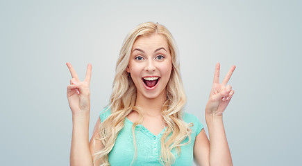 Image showing smiling young woman or teenage girl showing peace