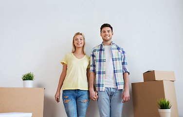 Image showing smiling couple with big boxes moving to new home