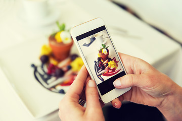 Image showing close up of woman picturing food by smartphone
