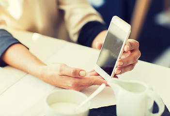 Image showing close up of women with smartphone at restaurant