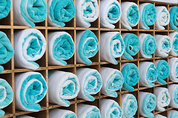 Image showing close up of shelf with rolled bath towels