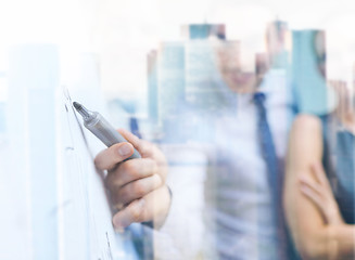 Image showing smiling business team with charts on flip board