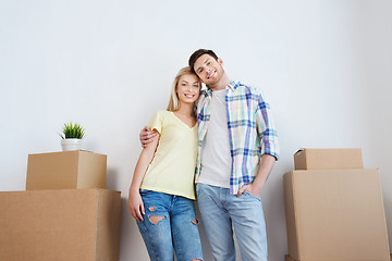 Image showing smiling couple with big boxes moving to new home