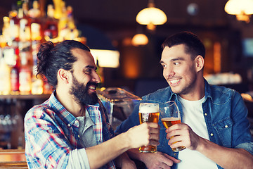 Image showing happy male friends drinking beer at bar or pub