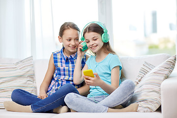 Image showing happy girls with smartphone and headphones