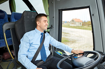 Image showing happy driver talking to microphone and driving bus