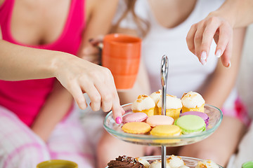 Image showing friends or teen girls eating sweets at home