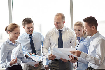 Image showing happy business people with papers talkig in office