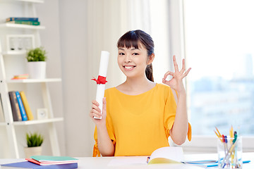 Image showing happy asian woman student with diploma at home