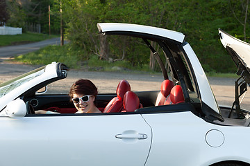 Image showing Woman Putting the Top Down