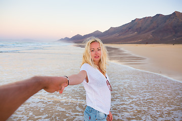 Image showing Romantic couple holding hands on beach.