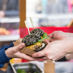 Image showing Beef burgers being served on street food stall