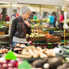 Image showing Woman buying vegetable at local food market. 