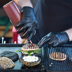 Image showing Beef burgers ready to serve on food stall.