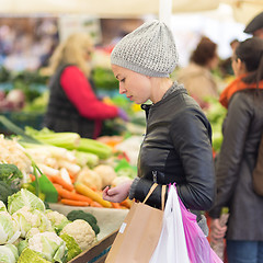 Image showing Woman buying vegetable at local food market. 