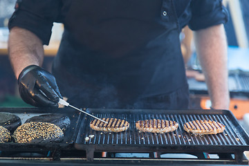 Image showing Beef burgers ready to serve on food stall.