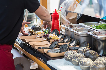 Image showing Burgers ready to serve on food stall.