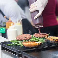 Image showing Beef burgers ready to serve on food stall.