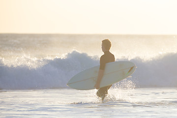 Image showing Surfers on beach with surfboard.