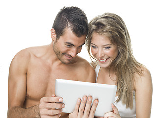 Image showing attractive couple watching things in a tablet