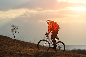 Image showing Man cyclist with backpack riding the bicycle