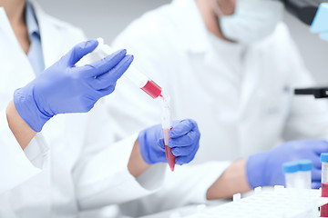 Image showing close up of scientists hands with test tube in lab