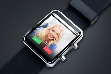 Image showing close up of black smart watch with incoming call