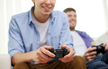 Image showing close up of friends playing video games at home