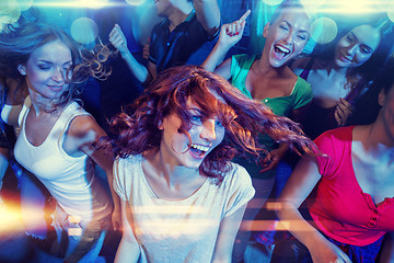 Image showing smiling friends dancing in club