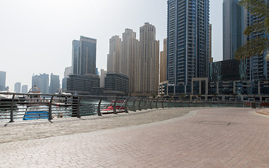 Image showing Dubai city seafront or harbor with boats