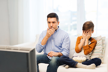 Image showing father and son watching horror movie on tv at home