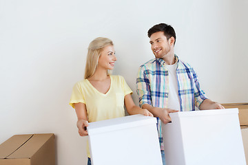 Image showing smiling couple with big boxes moving to new home