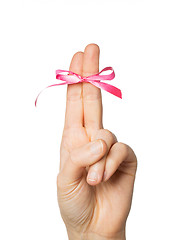 Image showing close up of two fingers tied by pink bow knot