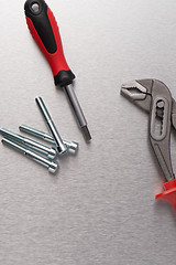 Image showing Spanner tool and screws