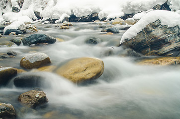 Image showing Rapidly flowing mountain river, blurred by a slow shutter speed