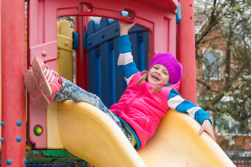 Image showing Five-year girl sitting on top of fun childrens slides